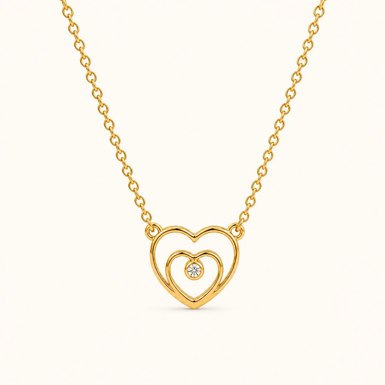 Double Heart Gold Pendant necklace featuring interlocking heart shapes with a sparkling center stone in yellow gold