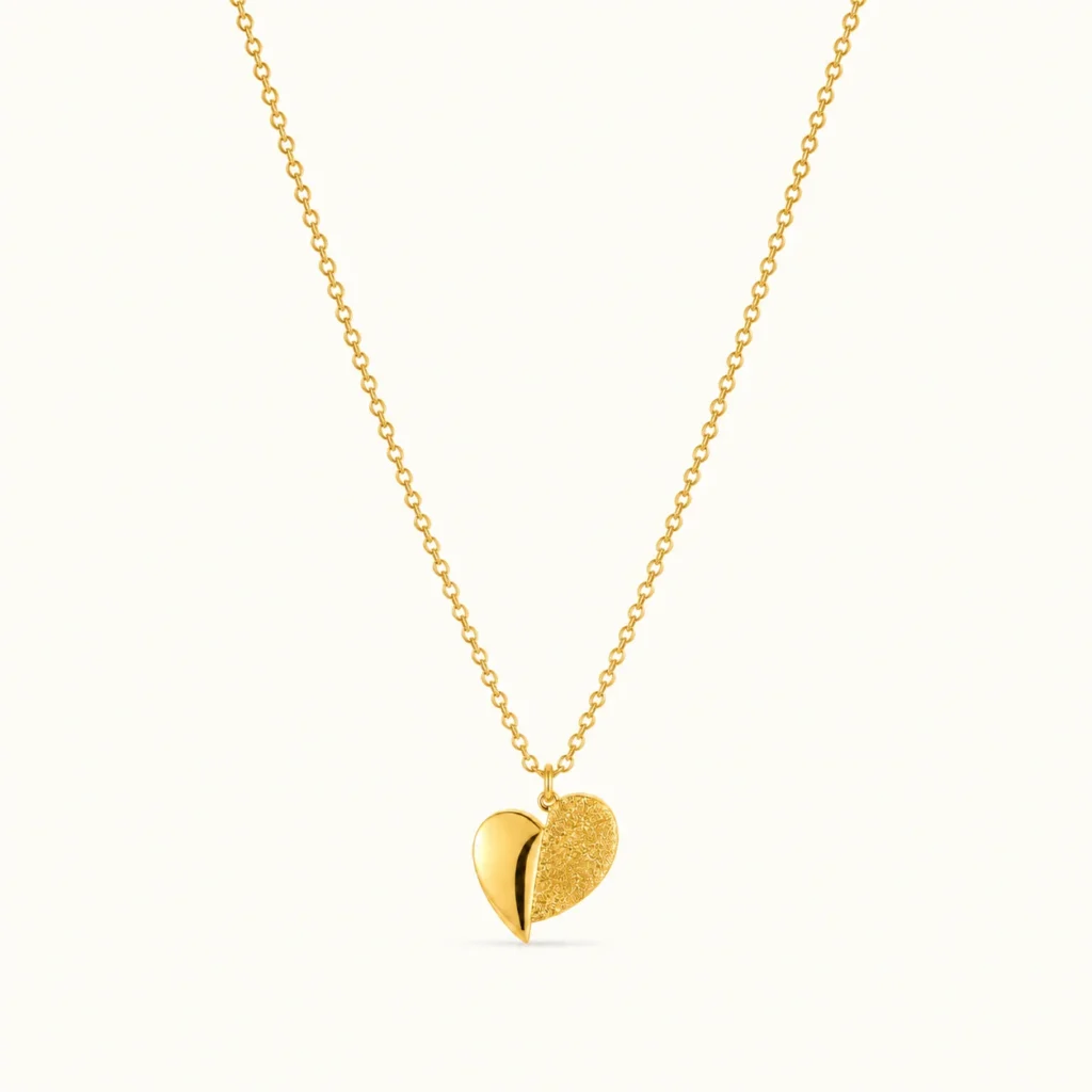 Dual Finish Heart Pendant Necklace featuring a polished gold heart and textured gold heart design on a delicate chain