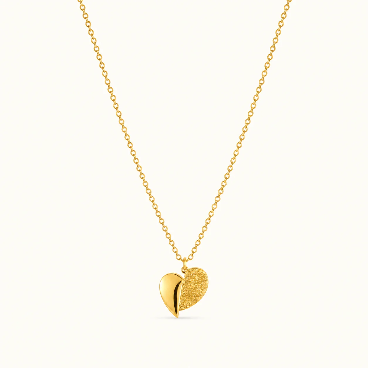 Dual Finish Heart Pendant Necklace featuring a polished gold heart and textured gold heart design on a delicate chain