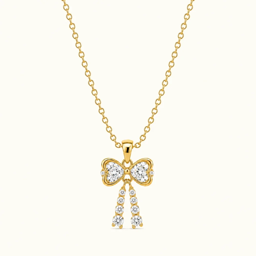Gold Bow Drop Pendant Necklace with sparkling round-cut stones and elegant dangling gemstone tassels in polished yellow gold finish