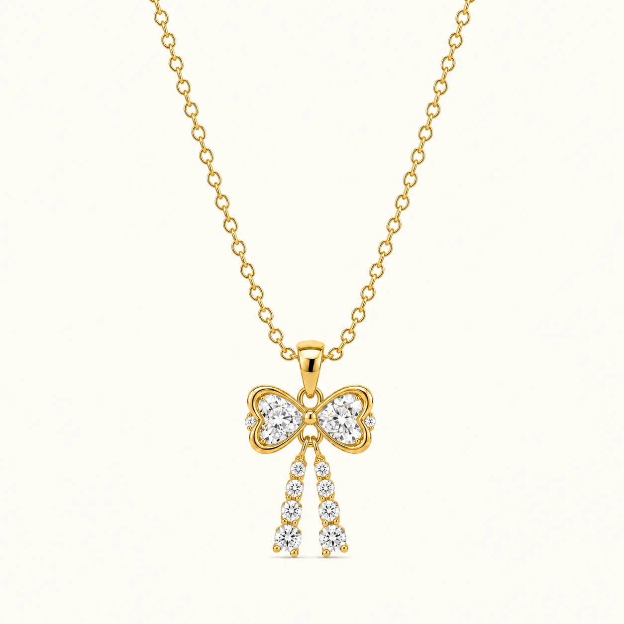 Gold Bow Drop Pendant Necklace with sparkling round-cut stones and elegant dangling gemstone tassels in polished yellow gold finish