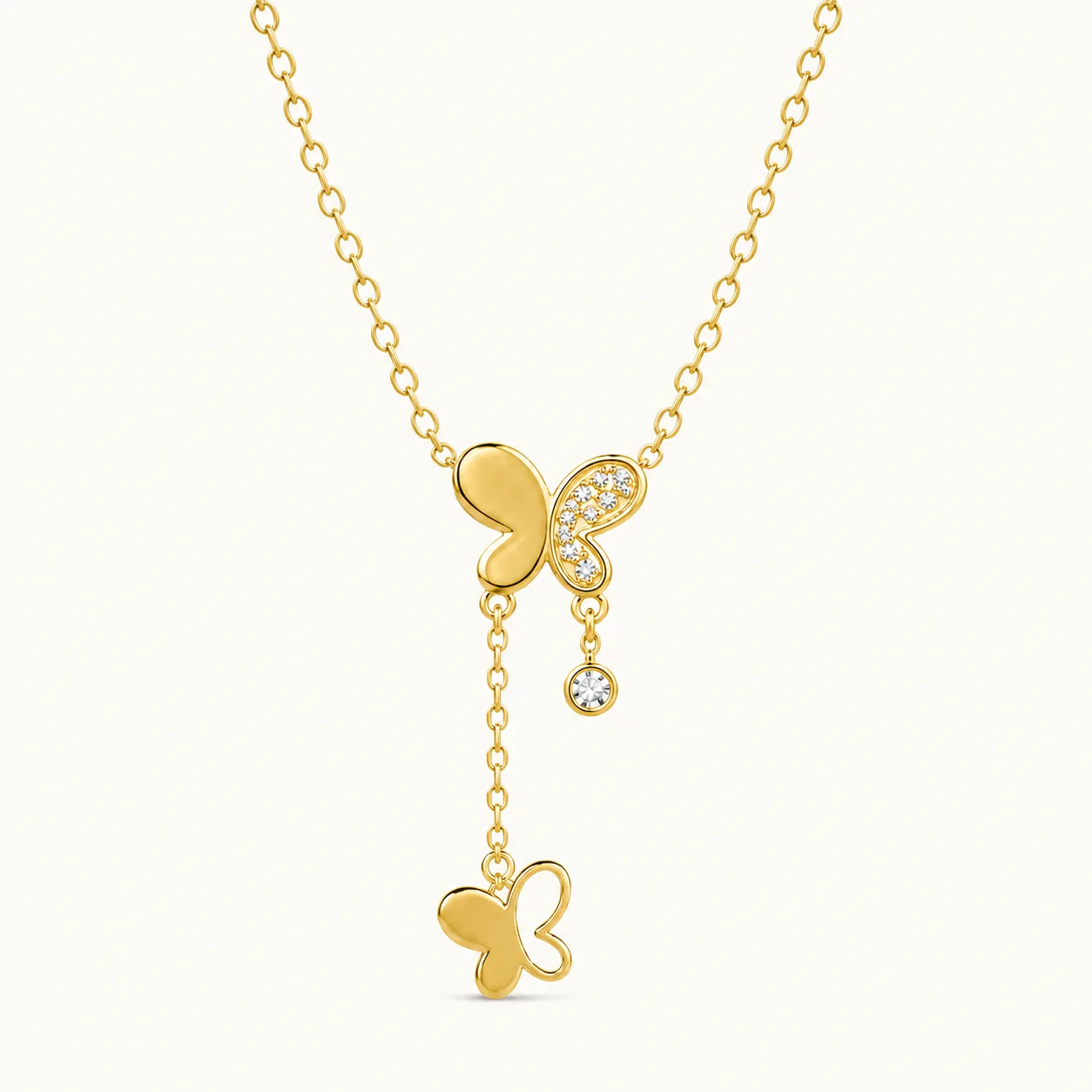Gold Butterfly Drop Necklace with cubic zirconia butterfly wing, dangling crystal accent, and cascading butterfly charm