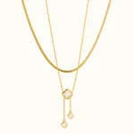 Gold Clover Layered Drop Necklace with mother of pearl clover pendants, double-layer chain, and elegant cascading drop accents
