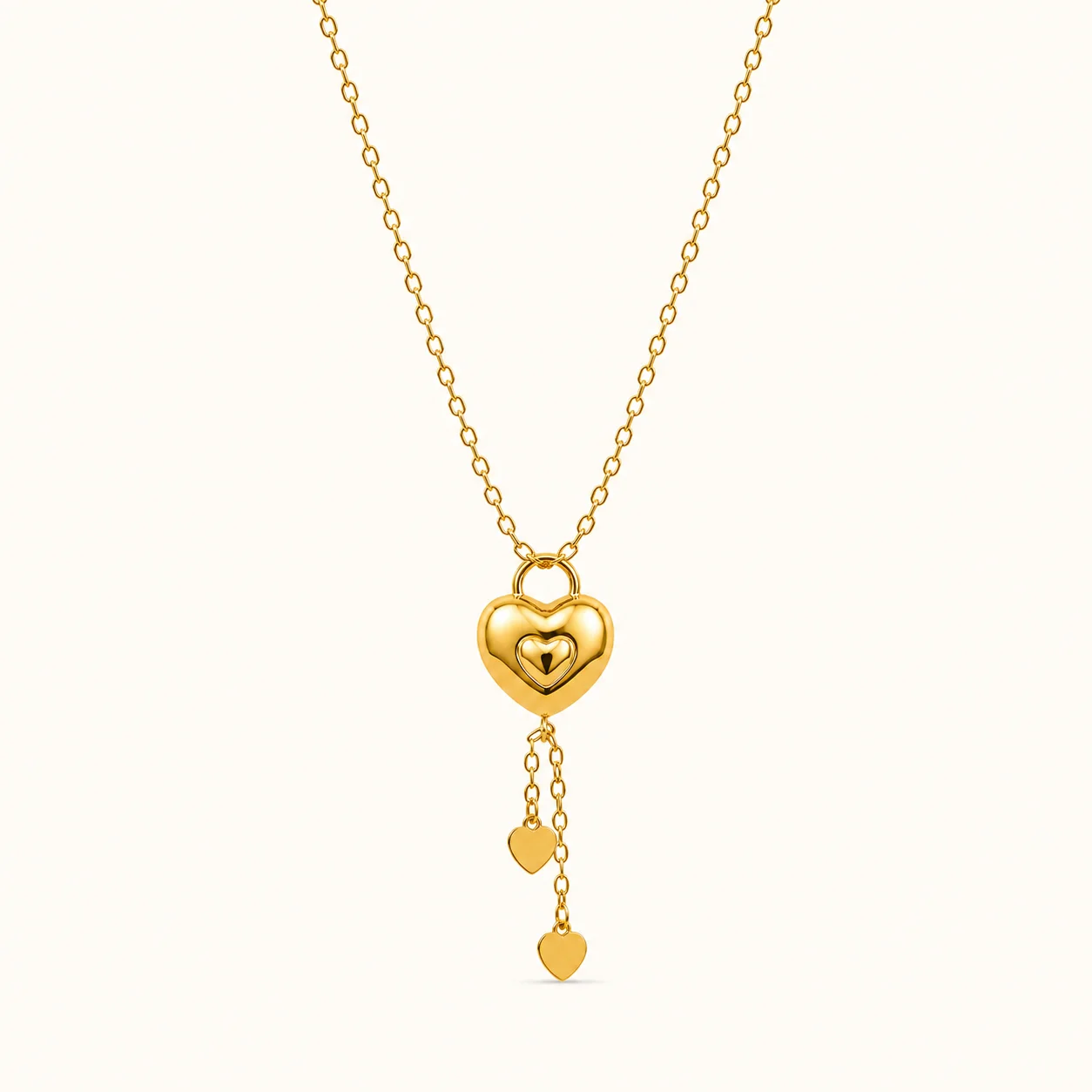 Gold Heart Tassel Pendant Necklace with layered heart pendant and dangling heart charm tassels in polished yellow gold finish