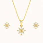 Snowflake Crystal Jewelry Set featuring a gold pendant necklace and matching stud earrings with champagne center stones and sparkling round and baguette crystals