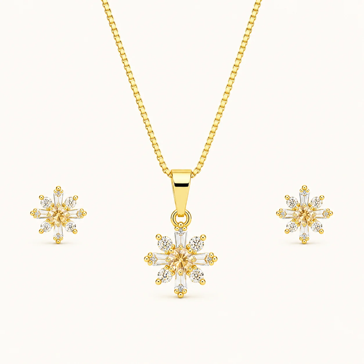 Snowflake Crystal Jewelry Set featuring a gold pendant necklace and matching stud earrings with champagne center stones and sparkling round and baguette crystals