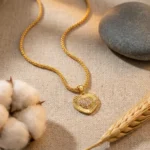 Divayra Aurelia Sunburst Heart Popcorn Chain Necklace with textured gold-tone pendant and clear pavé CZ centre