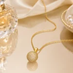 Divayra Celeste Pave Sphere Cable Chain Necklace with clear CZ crystal ball pendant and delicate gold-tone oval links
