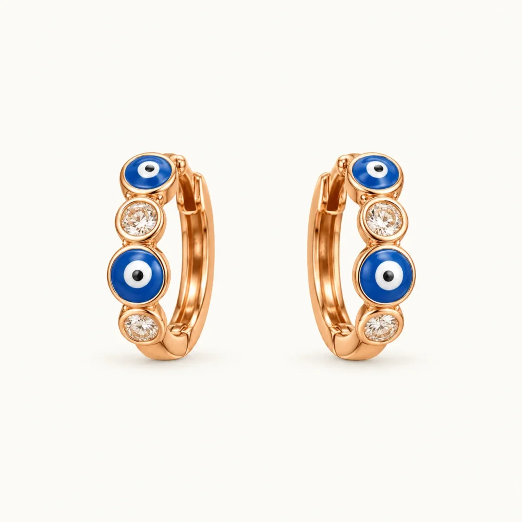Evil Eye (Nazar) Huggie Hoop Earrings featuring alternating blue enamel evil eye motifs and bezel-set clear round crystals