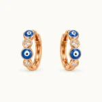 Evil Eye (Nazar) Huggie Hoop Earrings featuring alternating blue enamel evil eye motifs and bezel-set clear round crystals
