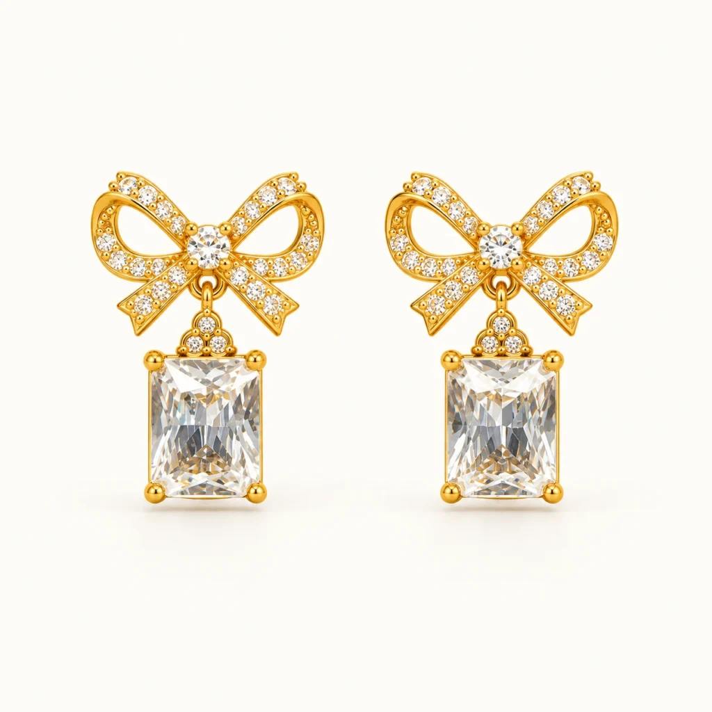 LumiBow Crystal Drop Earrings with gold bow design, sparkling white crystals, and rectangular crystal drops