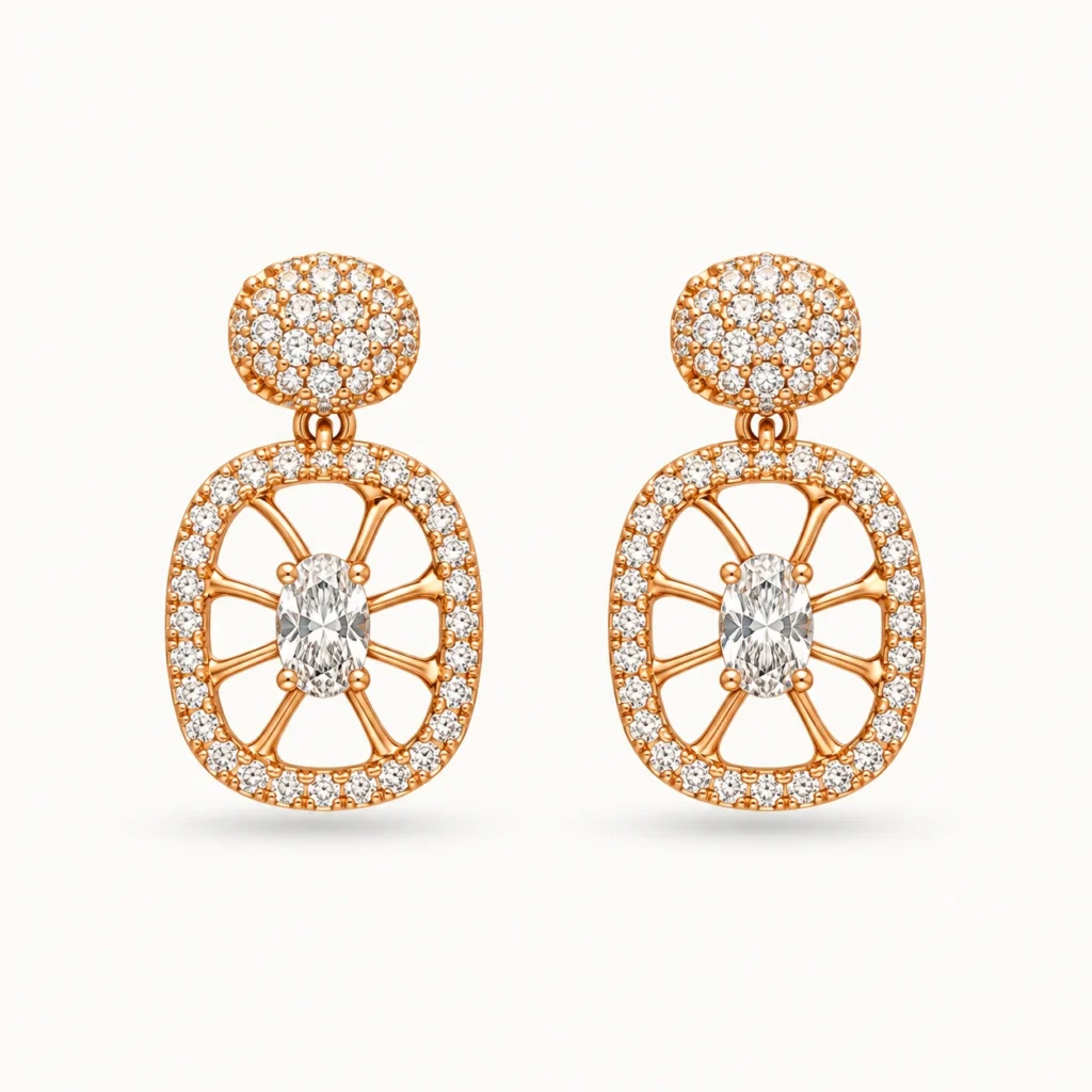 Oval Crystal Drop Earrings featuring a pavé round stud top and an openwork oval medallion with radial spokes and a central oval crystal in a gold finish