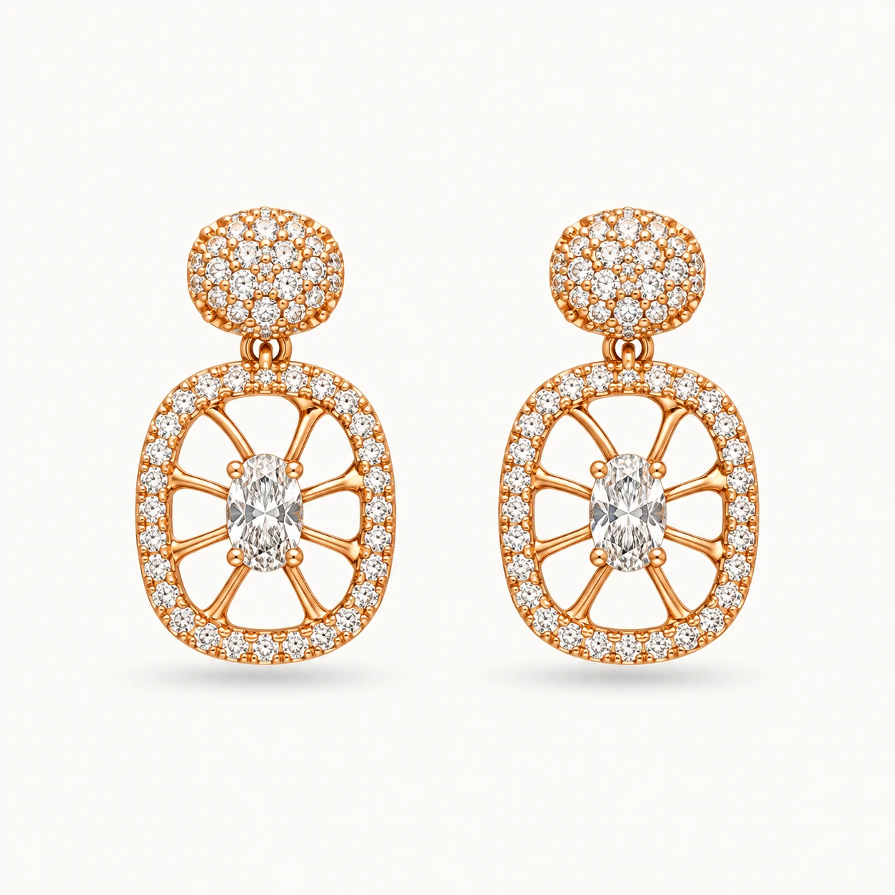 Oval Crystal Drop Earrings featuring a pavé round stud top and an openwork oval medallion with radial spokes and a central oval crystal in a gold finish