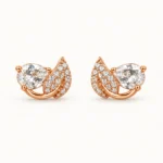 Pear Crystal Leaf Stud Earrings featuring a prong-set teardrop crystal and a curved micro-pavé leaf design